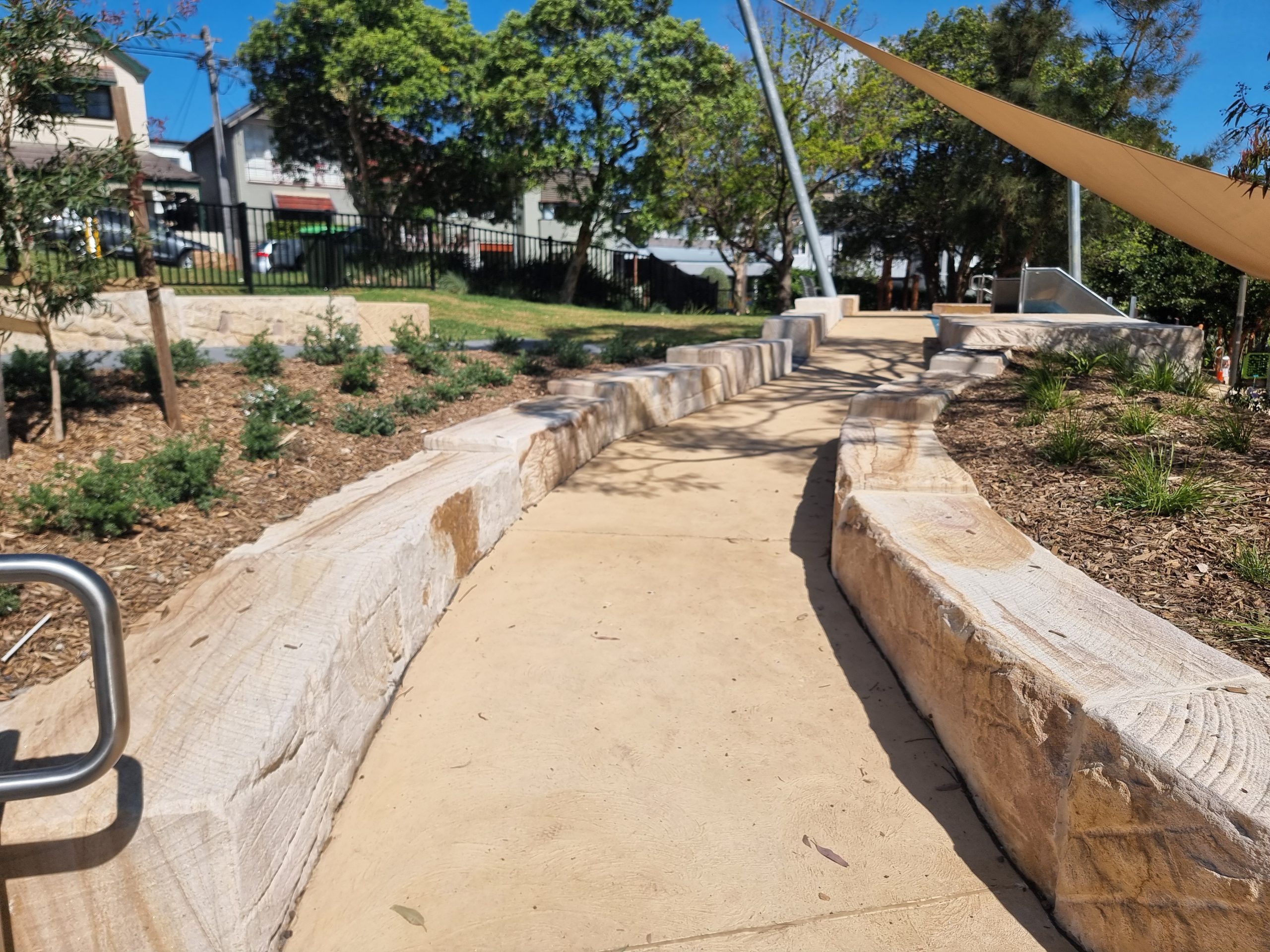 Detailed view of diamond and circular window cutouts framed in Gosford sandstone.